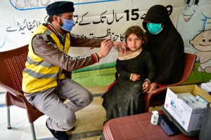 Child receiving vaccine injection in local health center